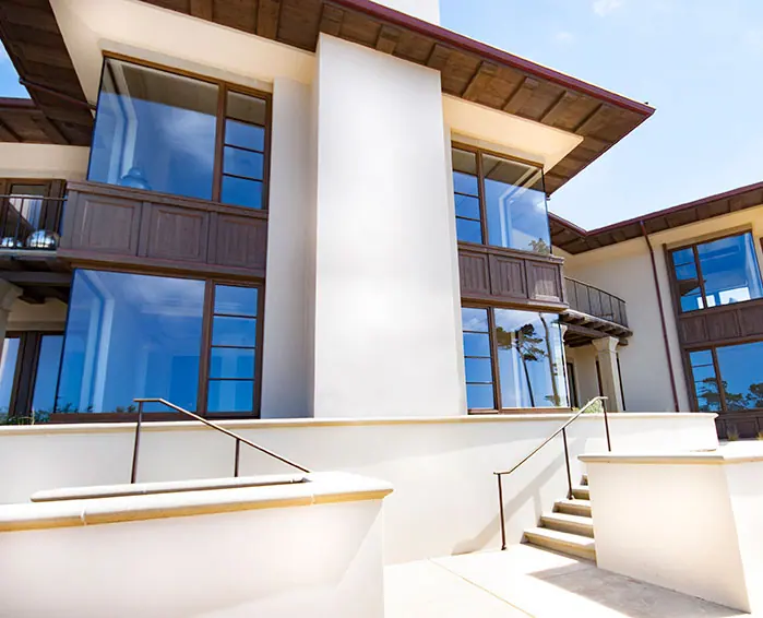 White stucco and timber-framed windows on a multi-level contemporary home
