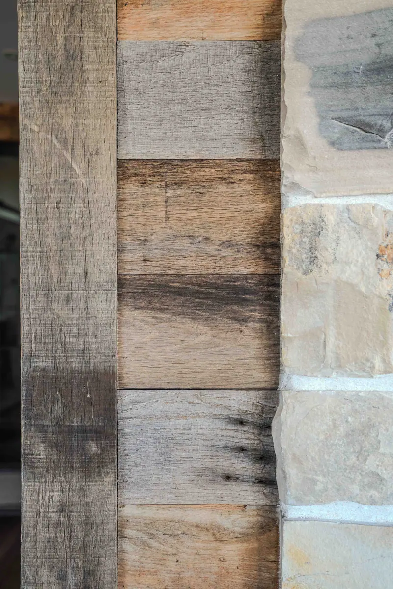 Reclaimed barn wood meets cut limestone in a close view of a wall