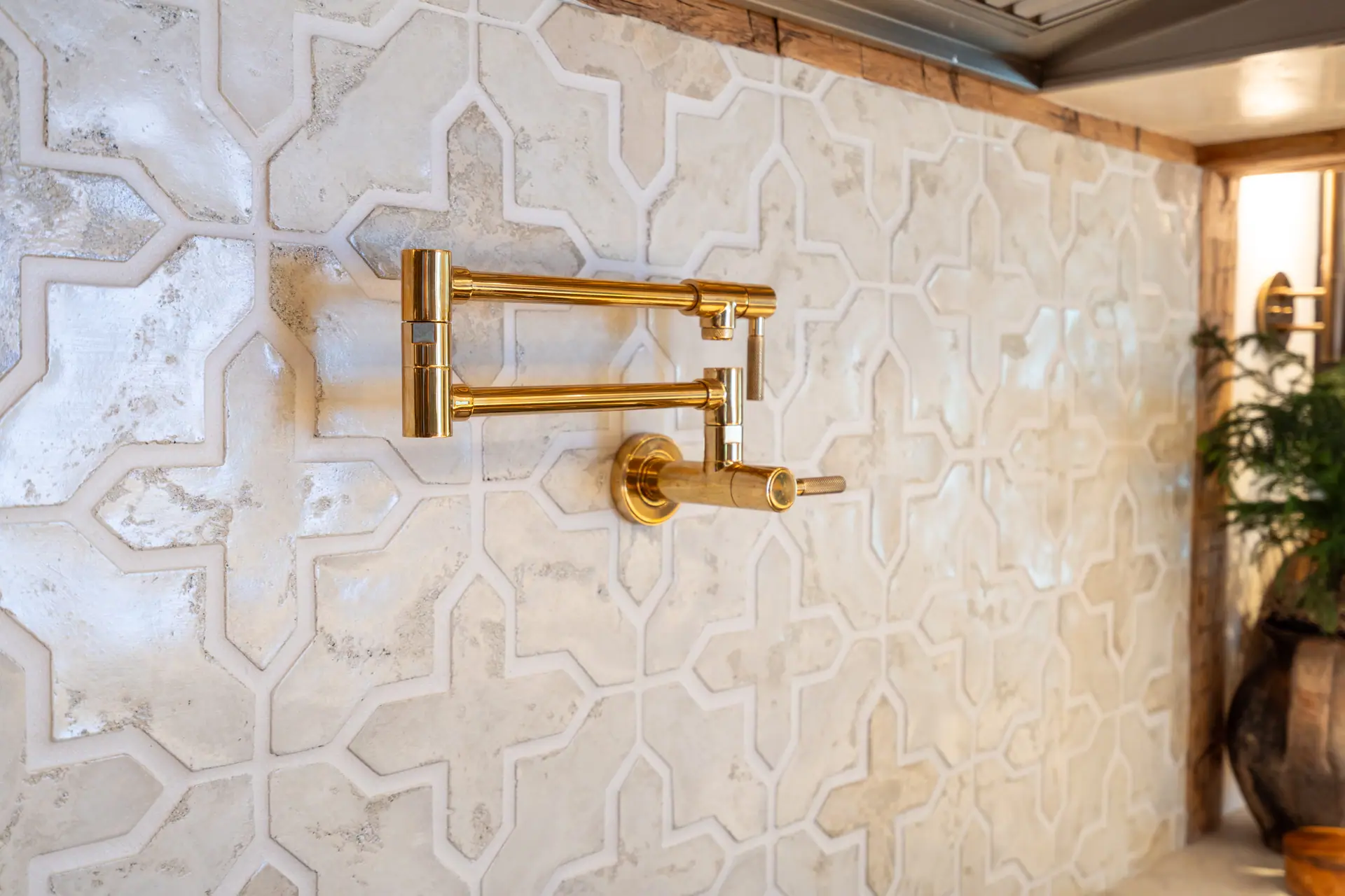 Brass pot filler against a hand-glazed Moorish tile backsplash