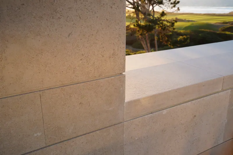 Limestone wall and stone sill framing a view of rolling fields